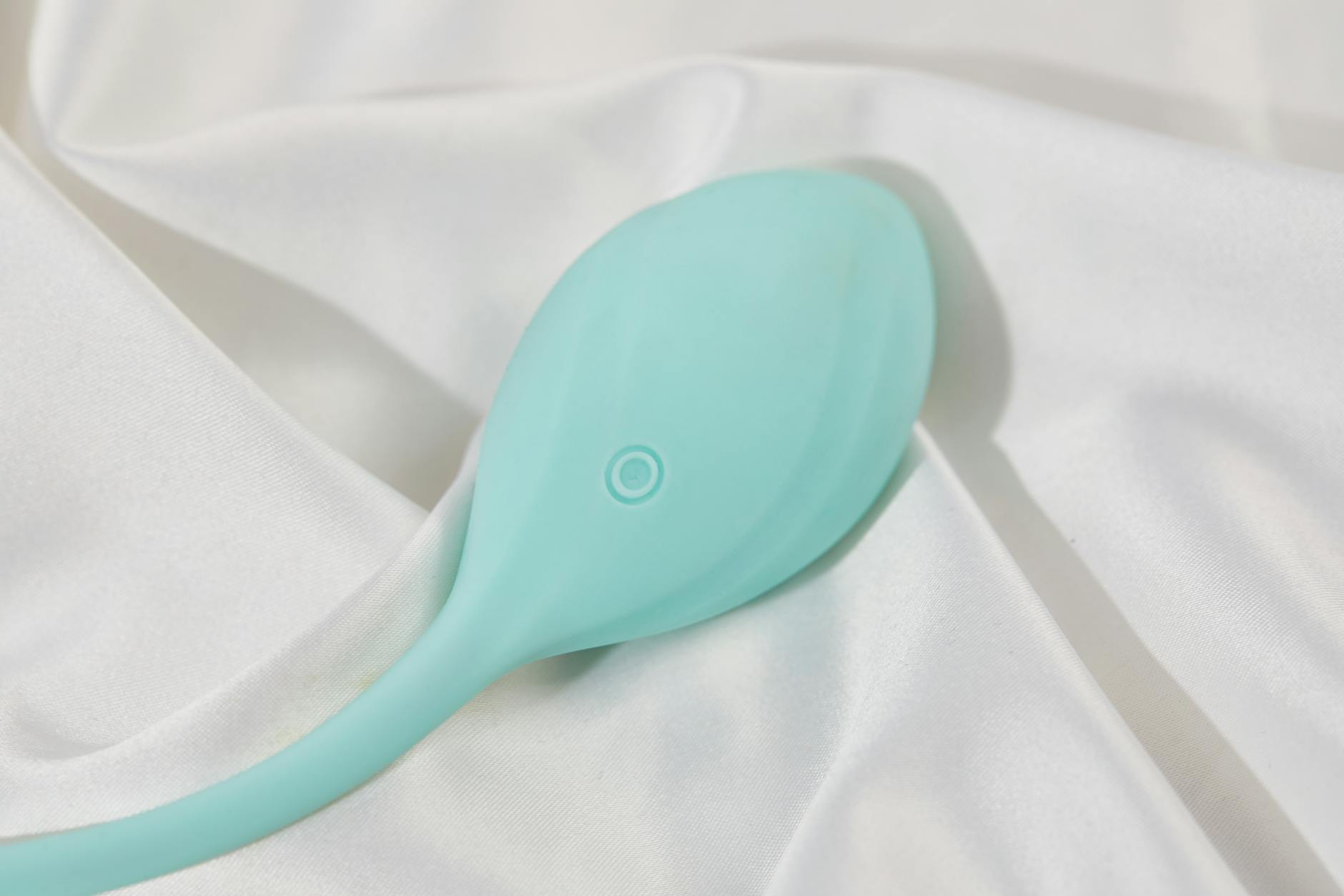 Pink lemon vibrator on purple background with candles, symbolizing intimate moments