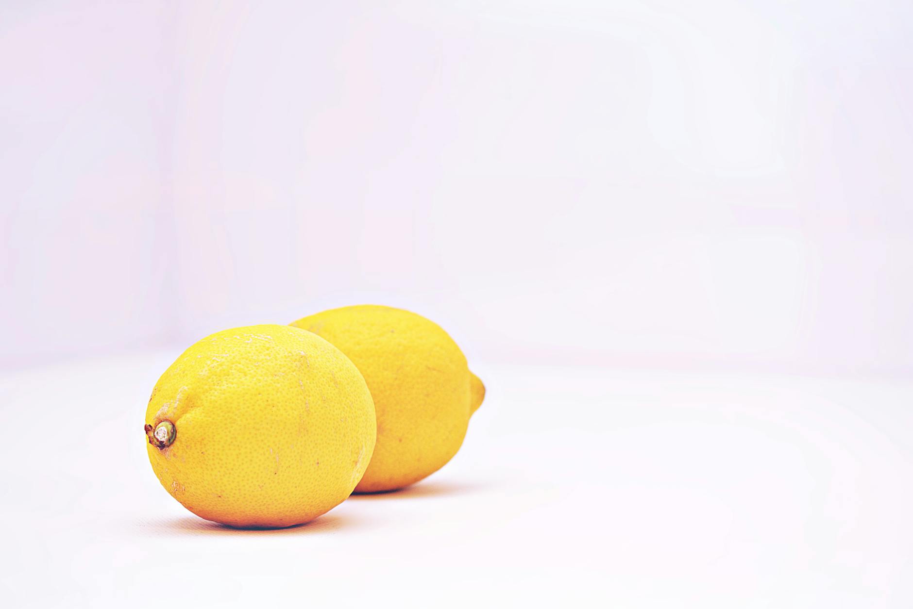 Fresh lemons on a white background, symbolizing natural sensitivity and gentle care