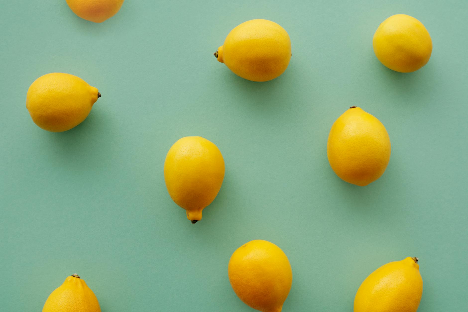 Bright yellow lemons on a pastel background, symbolizing the refreshing sensation of lemon vibrator technology